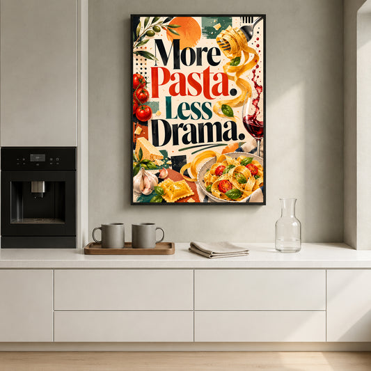A framed vertical kitchen wall art print with the text 'More Pasta, Less Drama.' hangs above a white countertop in a modern kitchen.