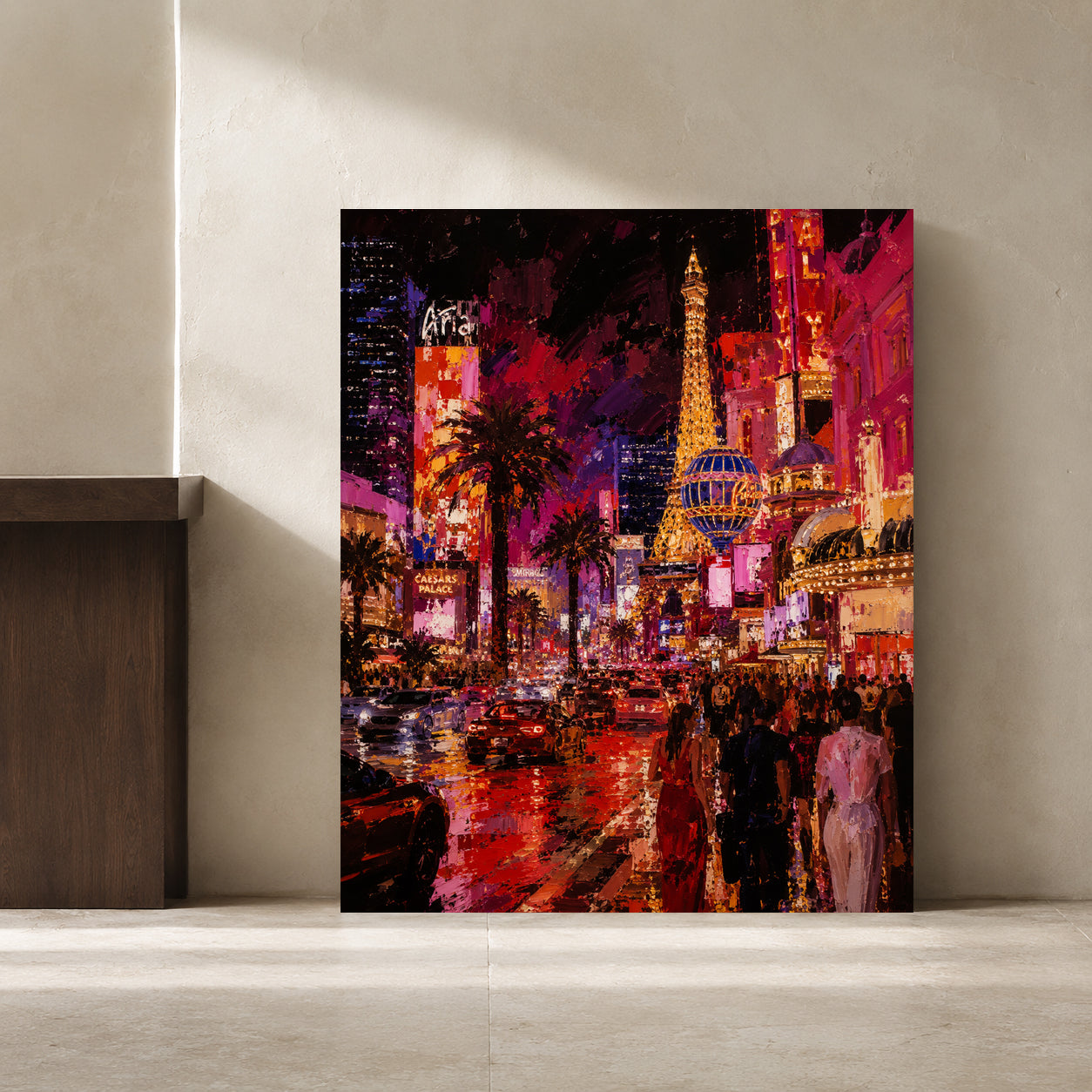 A vertical canvas art print depicting a vibrant, colorful Las Vegas night scene with palm trees, neon lights, and the Eiffel Tower, leaning against a neutral beige wall.