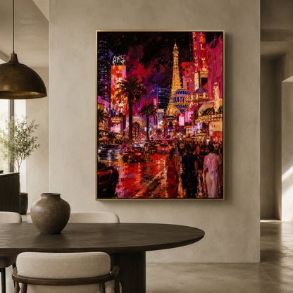 A large framed canvas print of a vibrant Las Vegas cityscape painting hangs on a beige wall in a modern dining room setting with a dark wood table and chairs.