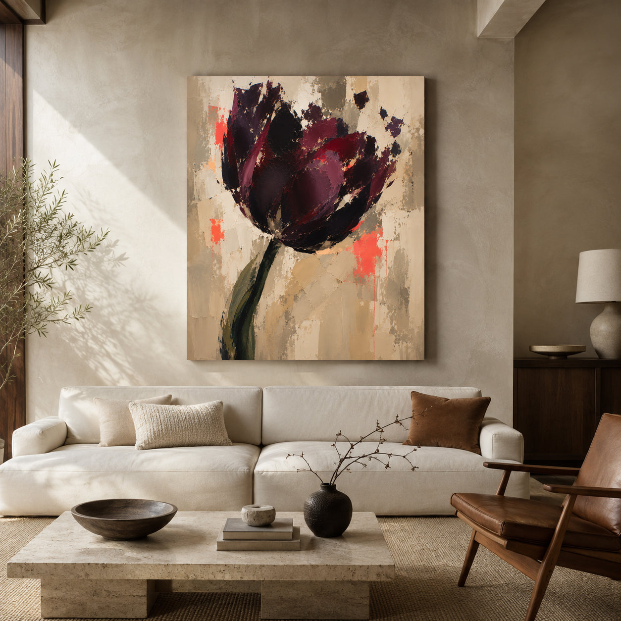 A large vertical canvas painting of an abstract dark purple tulip with red and orange accents, displayed on a beige wall above a modern white sofa in a styled living room.