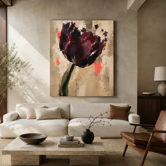A large vertical canvas painting of an abstract dark purple tulip with red and orange accents, displayed on a beige wall above a modern white sofa in a styled living room.