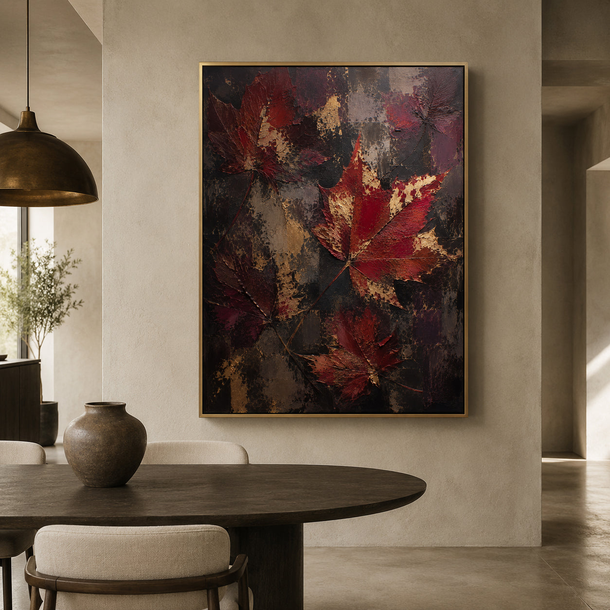 A framed abstract wall art print featuring large textured red and burgundy leaves over a dark charcoal and gold background, displayed in a modern dining room setting above a dark wood table.