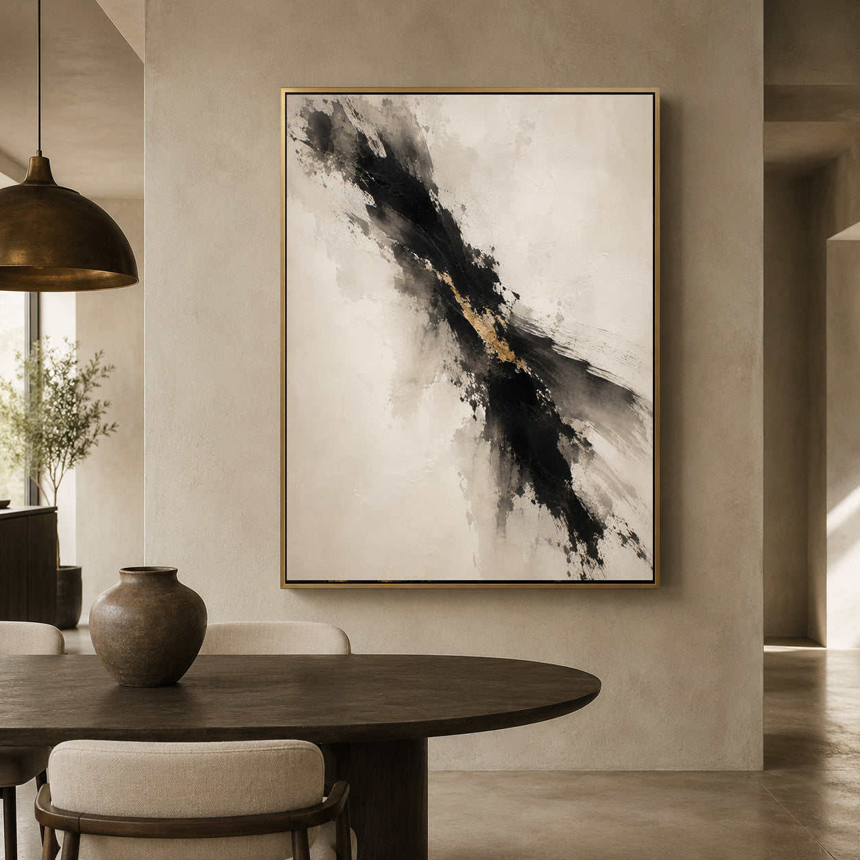 Abstract framed wall art hanging in a modern dining room. The artwork features a diagonal black and gray brushstroke pattern with a touch of gold on a warm off-white background, enclosed in a thin gold frame.