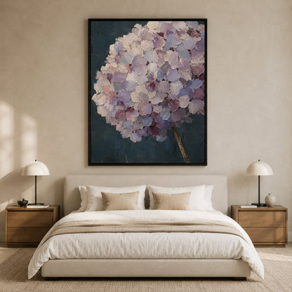 A large framed wall art print featuring a textured purple and lavender hydrangea bouquet on a dark blue background, displayed above a neatly made bed in a modern, neutral-toned bedroom.