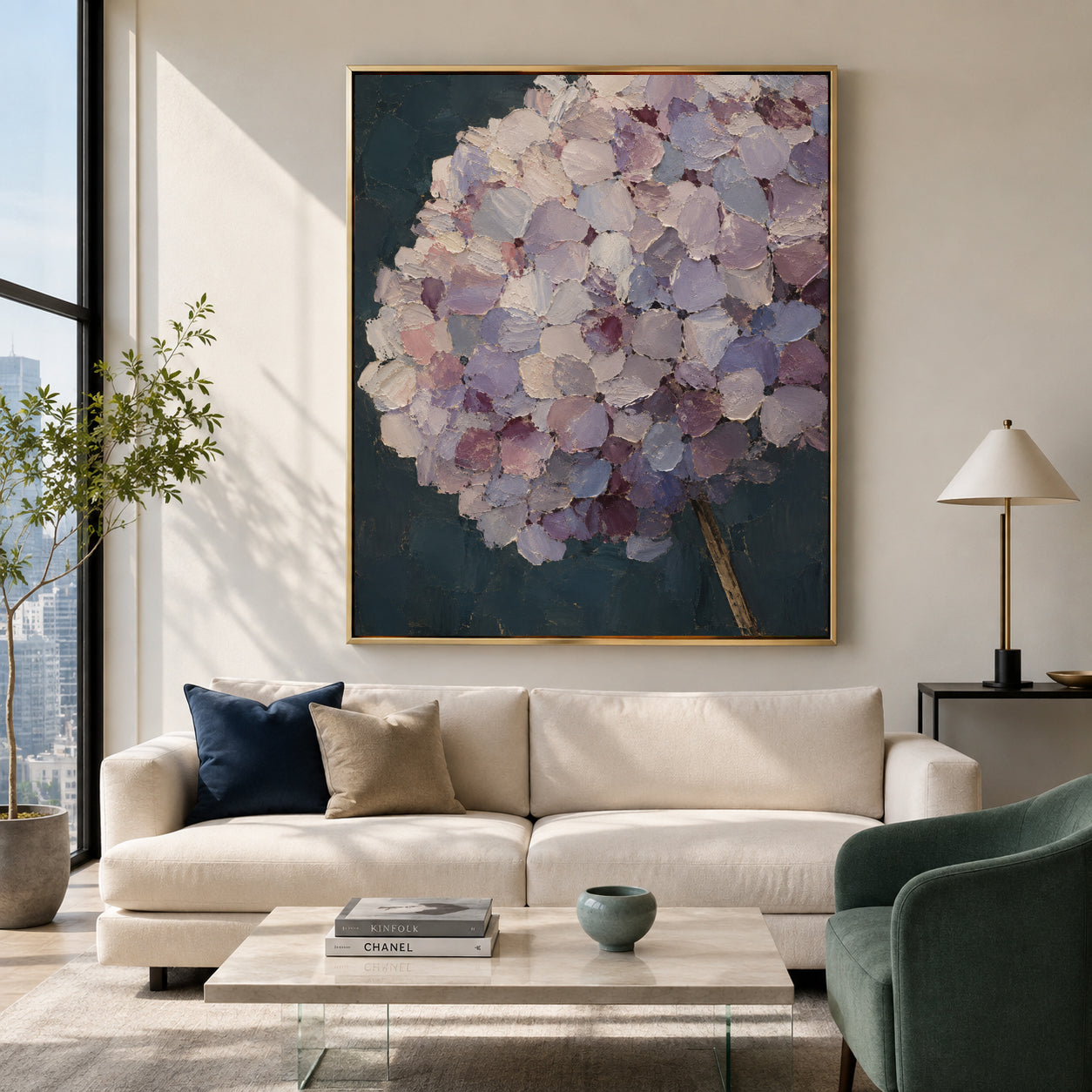 A large framed wall art print featuring a textured, painterly hydrangea bouquet in soft lavender, purple, and white tones against a dark teal background, displayed above a cream-colored sofa in a modern living room setting.