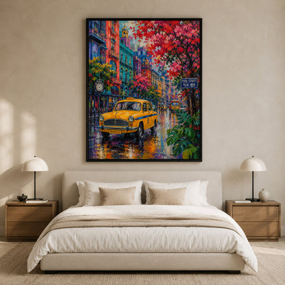 A large framed canvas print of a colorful city street scene with a yellow taxi and red flowering trees, displayed above a neatly made bed in a modern beige bedroom with two bedside lamps.