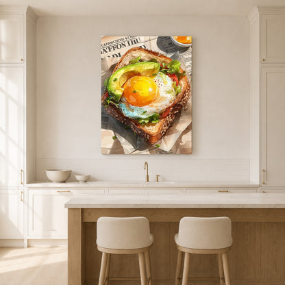 A vertical canvas wall art print depicting a gourmet avocado toast with a sunny egg, displayed in a bright, modern kitchen above a wooden island and two bar stools.
