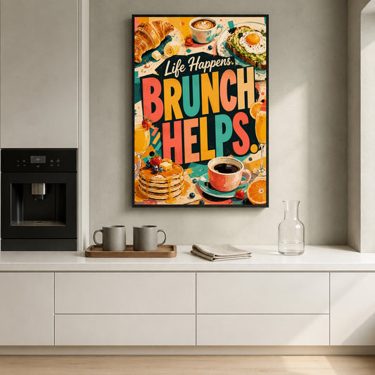 A colorful framed wall art print with the text 'Life Happens BRUNCH HELPS.' hangs on a light gray kitchen wall above a white countertop.
