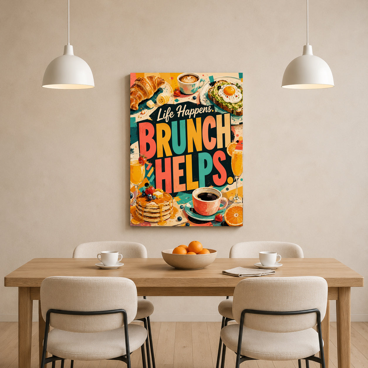 A colorful canvas wall art print featuring the text 'Life Happens BRUNCH HELPS.' with brunch food illustrations, displayed above a wooden dining table with chairs in a bright, modern dining room.