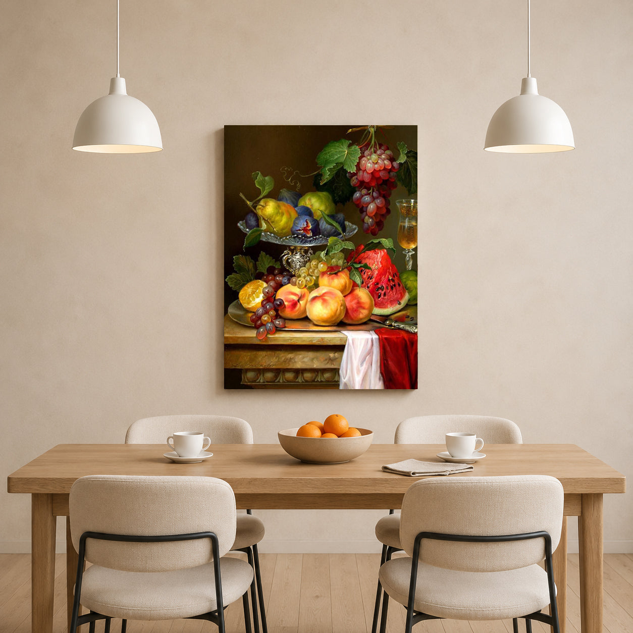 A vertical canvas wall art print featuring a classic still life of fresh fruit and grapes, displayed on a beige wall above a wooden dining table with four chairs and two hanging pendant lights.