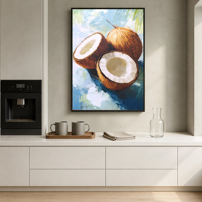 A framed vertical canvas print of a painted coconut still life hangs on a light beige wall above a white kitchen counter with mugs, a glass bottle, and an espresso machine.