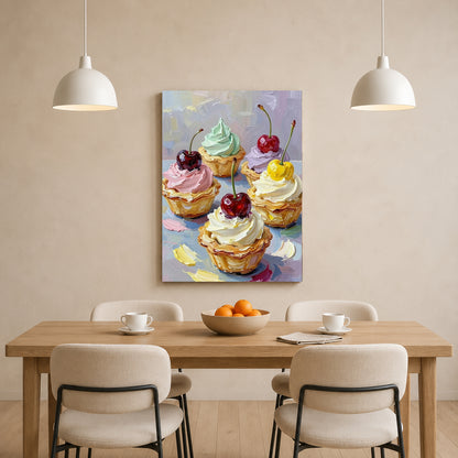 A vertical canvas art print depicting four decorated cupcakes with cherries, displayed on a beige wall above a wooden dining table with four chairs and two hanging pendant lights.