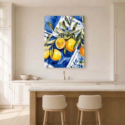 A vertical canvas wall art print featuring a vibrant blue and white watercolor-style background with yellow lemons and green leaves, displayed in a bright, modern kitchen above a counter and two stools.