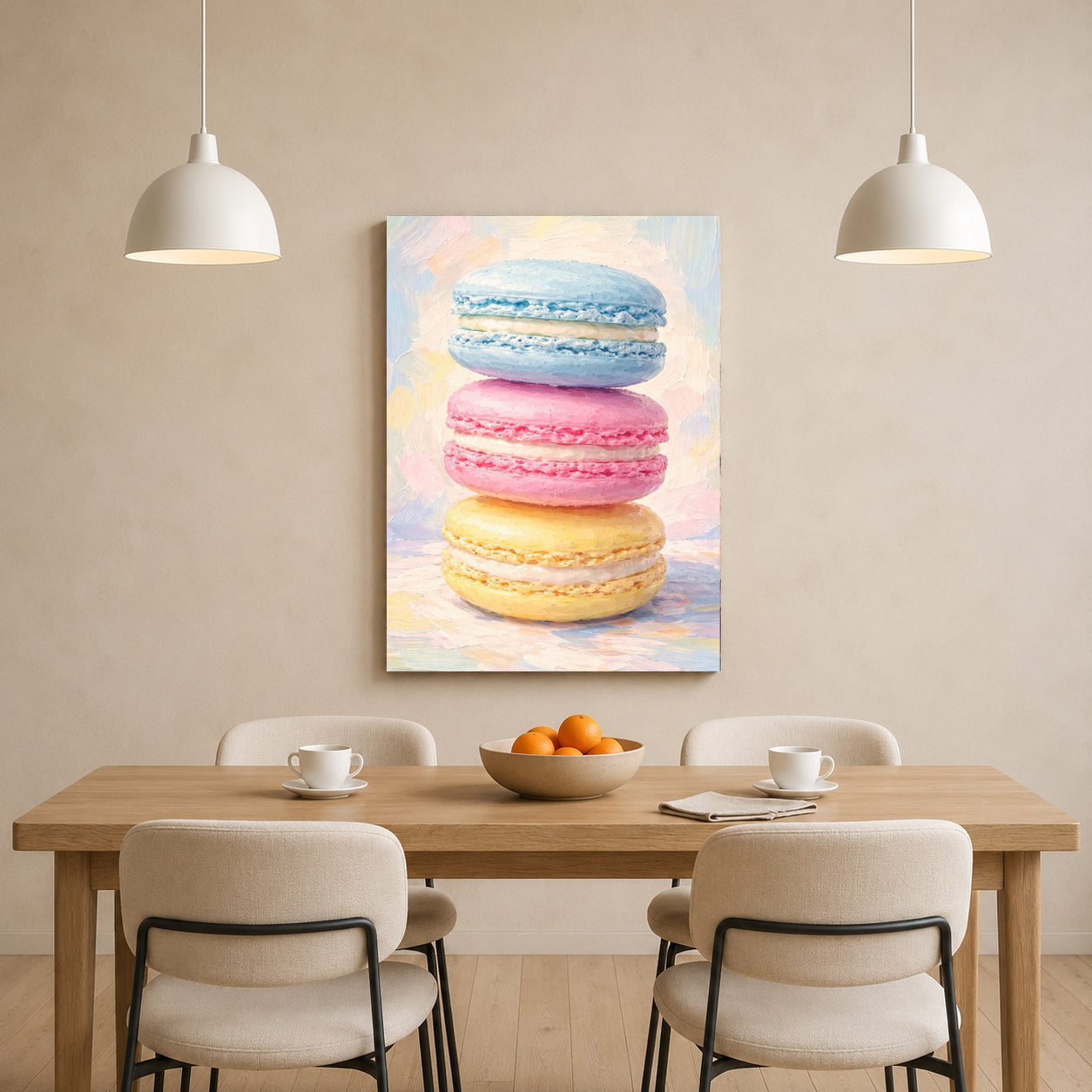 A vertical canvas wall art print featuring a stack of pastel macarons in blue, pink, and yellow, displayed on a beige dining room wall above a wooden table with chairs and pendant lights.