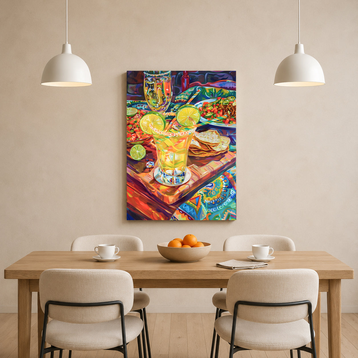 A colorful canvas wall art print depicting a vibrant still life of a margarita glass with lime slices, tortillas, and a drink, displayed on a beige wall above a wooden dining table with four chairs and two hanging pendant lights.