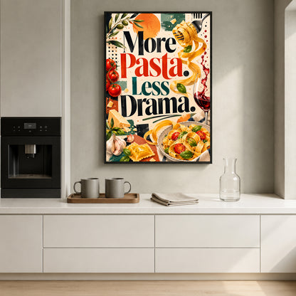 A framed vertical kitchen wall art print with the text 'More Pasta, Less Drama.' hangs above a white countertop in a modern kitchen.