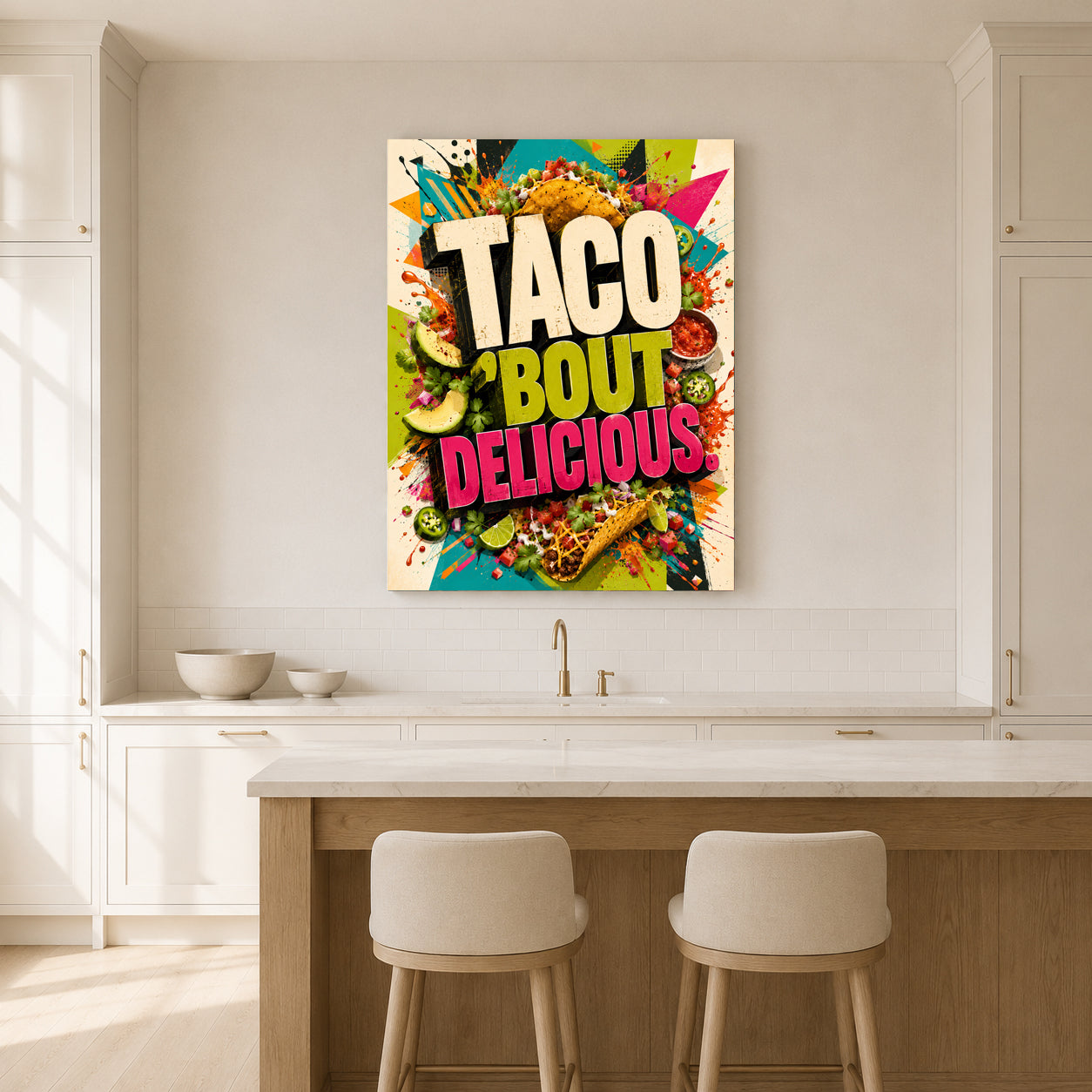 A colorful wall art canvas print featuring the text 'TACO BOUT DELICIOUS' surrounded by taco illustrations, displayed in a bright, modern kitchen above a counter with two stools.
