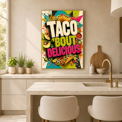 A framed colorful wall art print with the words “TACO BOUT DELICIOUS” hangs above a kitchen island. The artwork features bright taco illustrations, salsa, lime, and bold text in white, yellow, green, pink, and orange.
