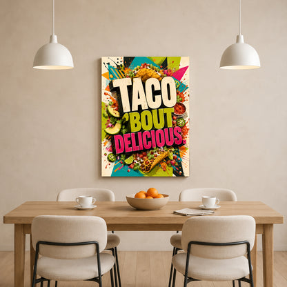 A colorful wall art print featuring the text 'TACO BOUT DELICIOUS' in bold letters over a vibrant taco-themed background, displayed above a wooden dining table with chairs in a modern dining room setting.
